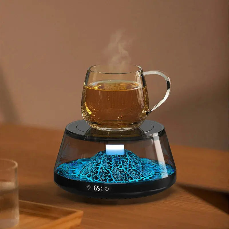 Smart Cup Warmer Volcano with blue volcanic lighting keeping a glass cup of steaming beverage warm on a wooden surface.