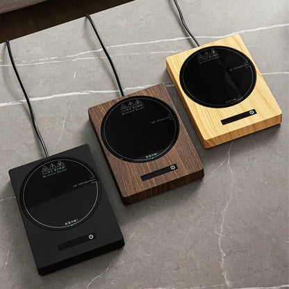 Comfort Life Cup Warmer on a marble surface in black, brown, and wood finishes.