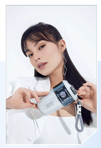 Elegant woman holding Water Monster Smart Coffee Cup, showcasing its sleek design and customizable LED screen.